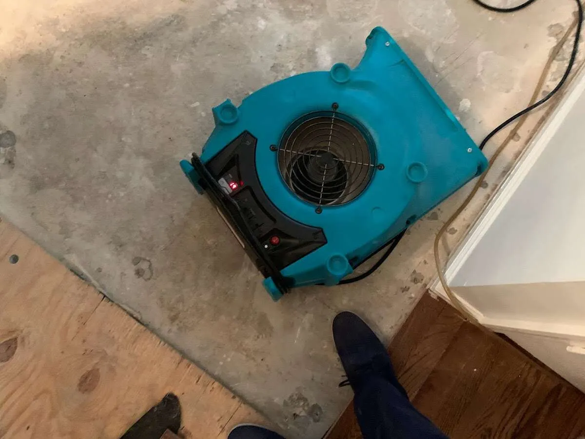 Air mover drying subfloor during Commercial Water Damage Restoration in Lakeland